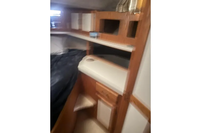 Slide: The Image of 1987 Mainship 36 Nantucket Sedan interior with wooden cabinetry and shelving. - 17