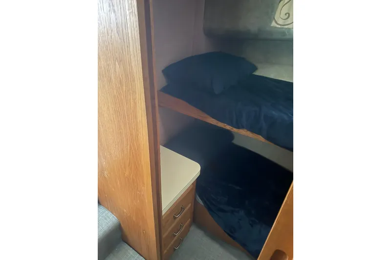 Slide: The Image of 1987 Mainship 36 Nantucket Sedan interior with wooden bunk beds and storage drawers. - 19