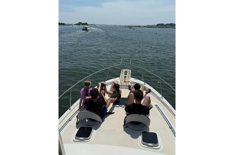 Slide: The Image of People relaxing on a 1987 Mainship 36 Nantucket Sedan boat, enjoying a sunny day on the water. - 2