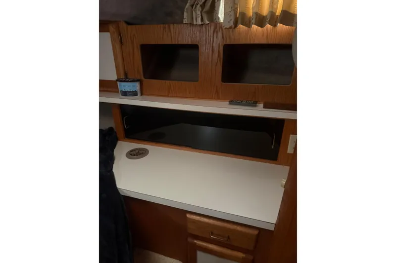 Slide: The Image of 1987 Mainship 36 Nantucket Sedan interior with wooden cabinetry and white countertop. - 20