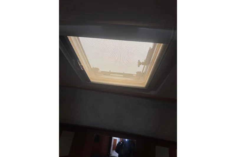 Slide: The Image of Hatch window inside 1987 Mainship 36 Nantucket Sedan boat, viewed from below. - 23