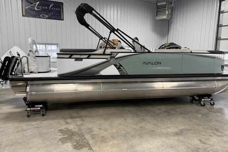 The Image of 2026 Avalon LSZ Quad Lounge pontoon boat in a showroom setting. - 1
