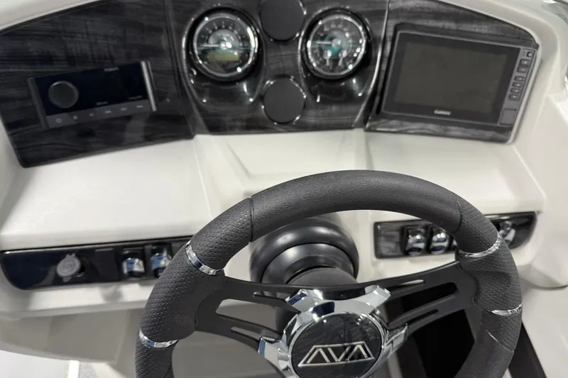 Slide: The Image of Steering console of 2026 Avalon LSZ Quad Lounge boat with modern controls and gauges. - 12