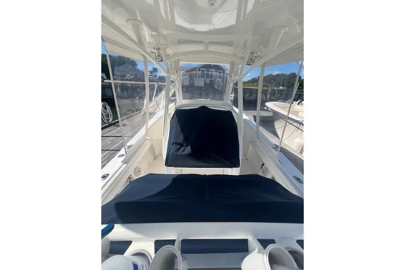 Slide: The Image of 2017 Regulator 31 boat interior with covered seating and clear windows. - 10
