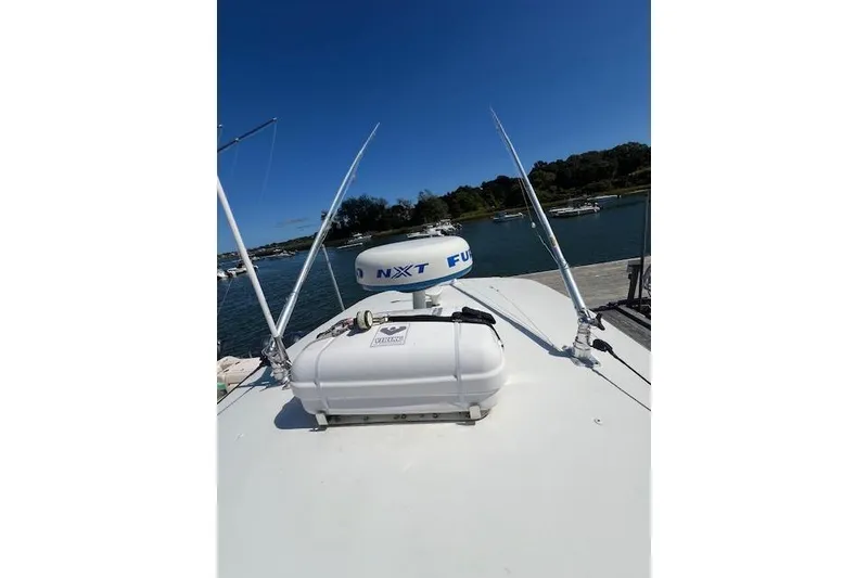 Slide: The Image of 2017 Regulator 31 boat with radar and antennas docked by the water. - 12