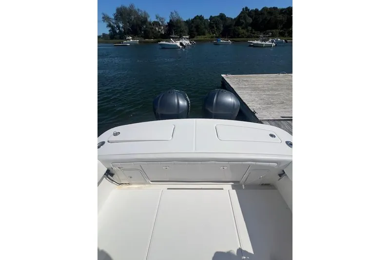Slide: The Image of 2017 Regulator 31 boat with dual engines docked on a sunny day. - 15