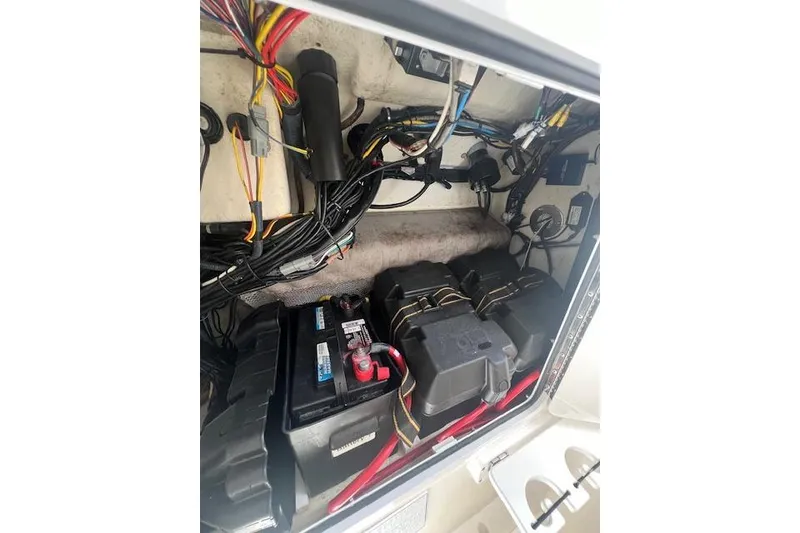 Slide: The Image of 2017 Regulator 31 boat battery compartment with wiring and electrical components. - 16