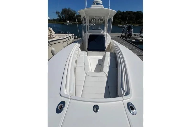 Slide: The Image of 2017 Regulator 31 boat with sleek white deck and seating, docked by the water. - 19