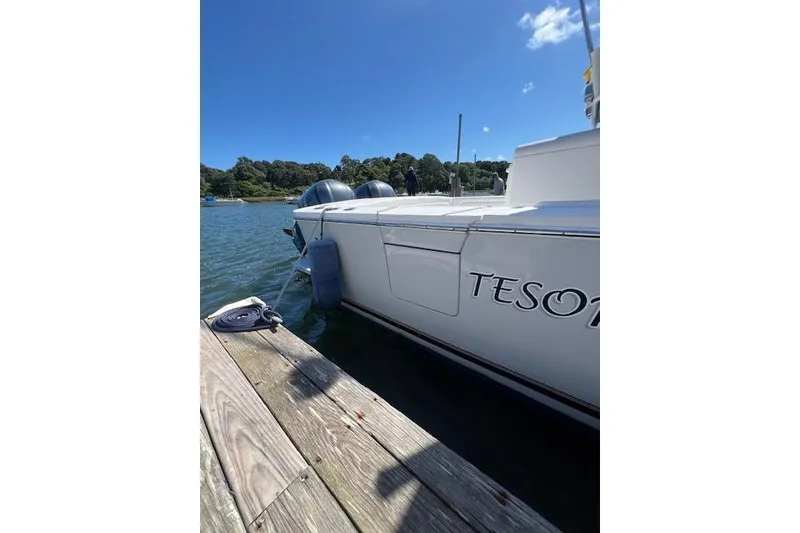 Slide: The Image of 2017 Regulator 31 boat docked by a wooden pier on a sunny day. - 21
