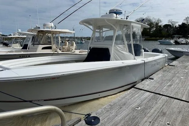 Slide: The Image of 2017 Regulator 31 boat docked, featuring sleek design and fishing rods. - 3