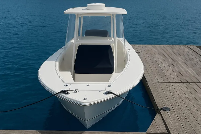 Slide: The Image of 2017 Regulator 31 boat docked on clear blue water. - 4