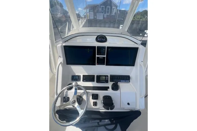 Slide: The Image of 2017 Regulator 31 boat dashboard with steering wheel and electronic displays. - 6