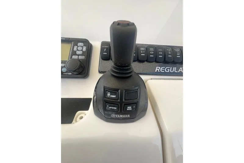 Slide: The Image of Yamaha joystick control on 2017 Regulator 31 boat dashboard with navigation buttons. - 7