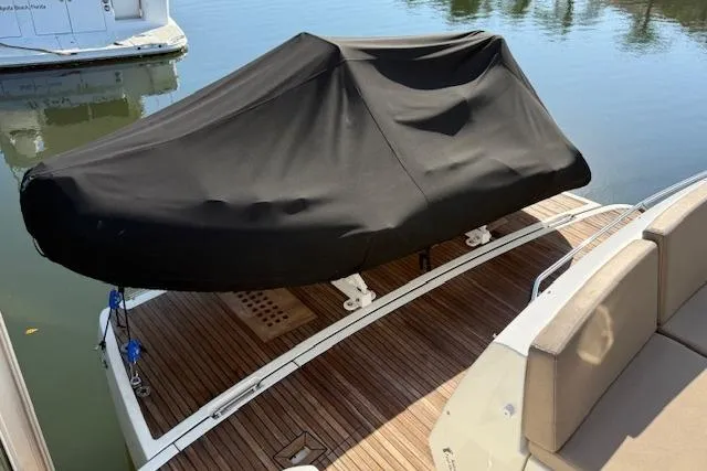 Slide: The Image of Luxury 2015 Prestige 500 yacht docked by waterfront home. - 13