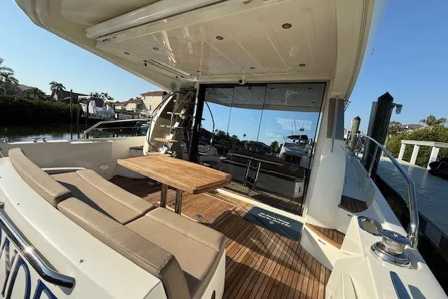 Slide: The Image of 2015 Prestige 500 yacht docked in urban marina with cityscape background. - 14