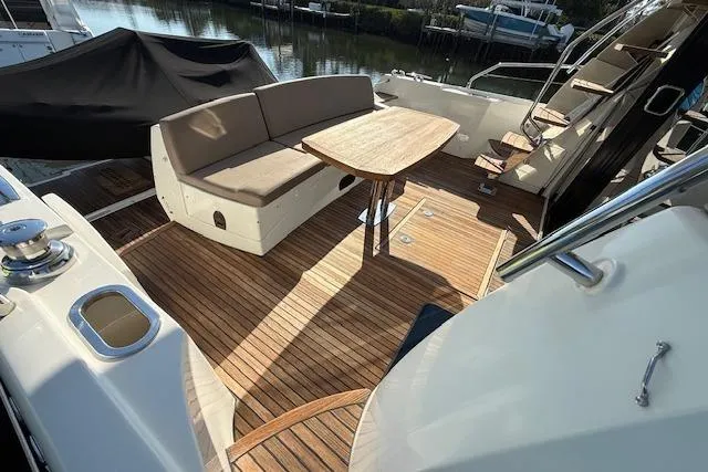 Slide: The Image of 2015 Prestige 500 yacht docked at marina, with cityscape background. - 15