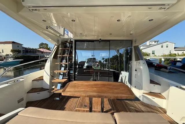 Slide: The Image of 2015 Prestige 500 yacht with sunshade, docked in a marina. - 17