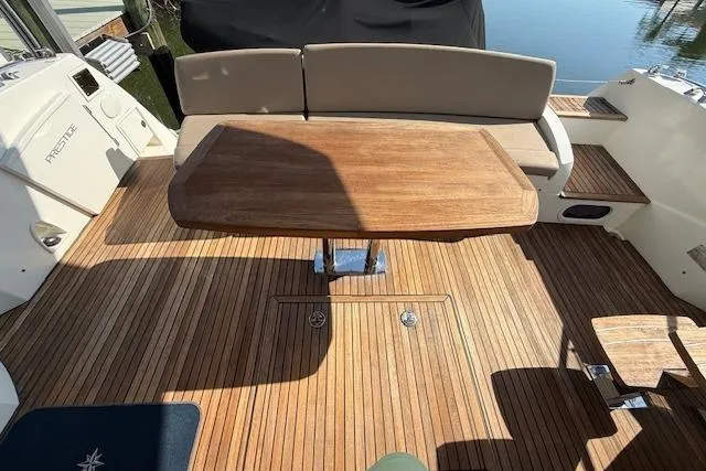 Slide: The Image of 2015 Prestige 500 yacht docked at marina, featuring sleek design and spacious deck. - 18