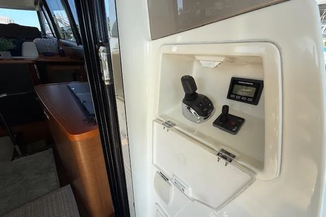 Slide: The Image of Covered boat on Prestige 500 yacht's wooden deck, 2015 model, docked on calm water. - 19