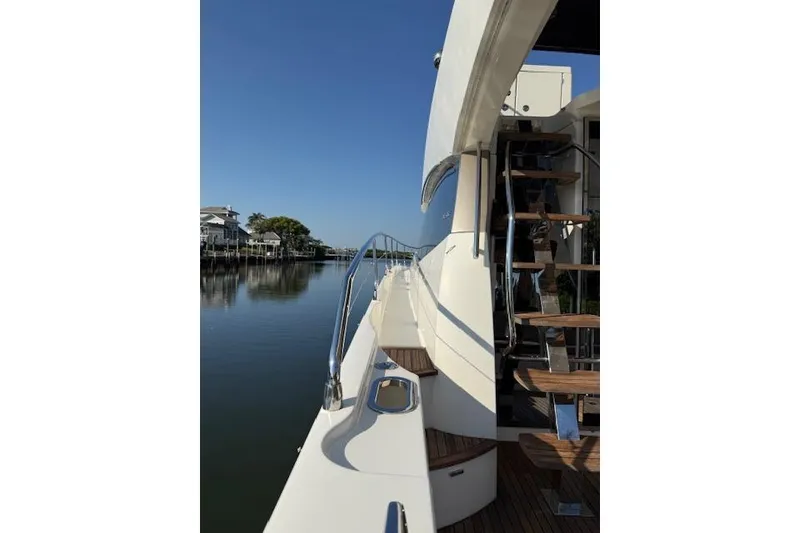 Slide: The Image of Luxury 2015 Prestige 500 yacht with spacious deck, elegant seating, and wooden table. - 20