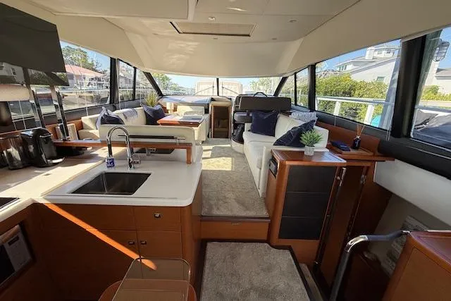 Slide: The Image of Luxurious 2015 Prestige 500 yacht with spacious deck, seating, and wooden table. - 22