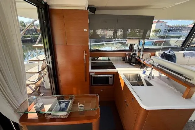 Slide: The Image of Luxurious 2015 Prestige 500 yacht interior with wooden table and seating area. - 23