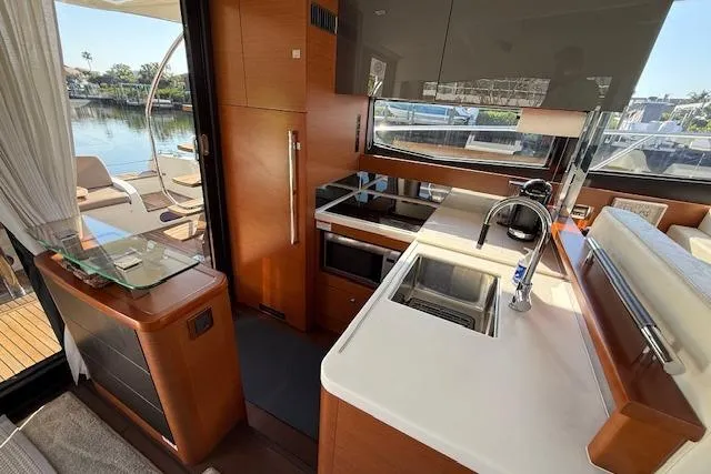 Slide: The Image of Prestige 500 yacht deck with wooden table and seating, 2015 model. - 24