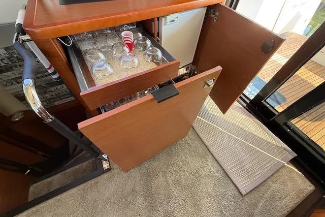 Slide: The Image of 2015 Prestige 500 yacht side view with wooden steps, docked by calm waters. - 26