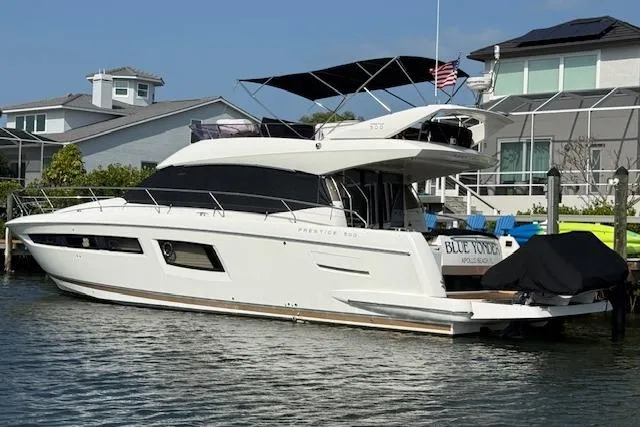 Slide: The Image of 2015 Prestige 500 yacht docked, featuring sleek design and "Blue Yonder" nameplate. - 4