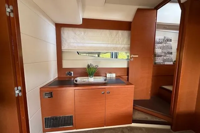 Slide: The Image of Interior of a 2015 Prestige 500 yacht with wooden cabinetry and stairs leading below deck. - 58