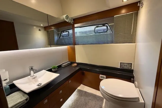 Slide: The Image of Luxurious interior of a 2015 Prestige 500 yacht, featuring a cozy bedroom and modern amenities. - 59