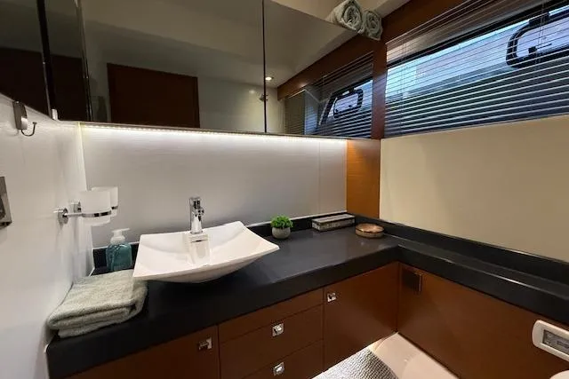 Slide: The Image of Luxurious cabin interior of a 2015 Prestige 500 yacht with cozy bedding and seating area. - 60