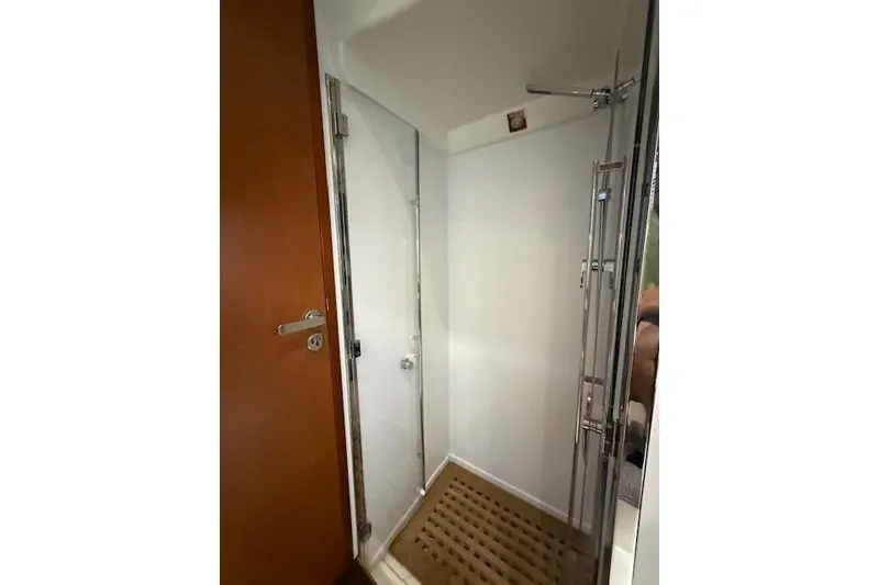 Slide: The Image of Luxurious cabin interior of a 2015 Prestige 500 yacht with a cozy bed and elegant decor. - 61