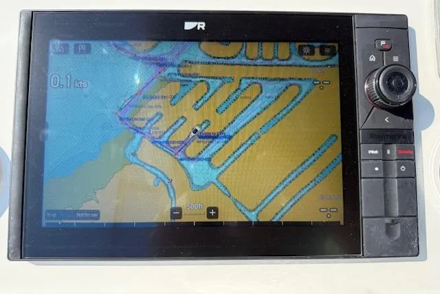 Slide: The Image of 2015 Prestige 500 yacht deck with seating and table, docked near waterfront homes. - 68