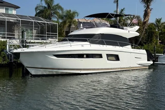 Slide: The Image of 2015 Prestige 500 yacht docked at marina under clear sky. - 7
