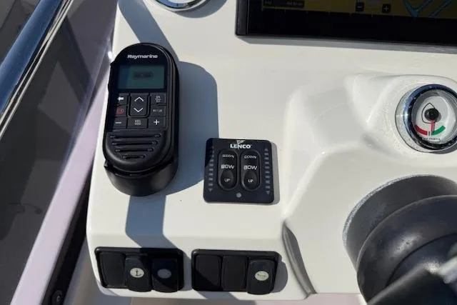 Slide: The Image of Helm of 2015 Prestige 500 yacht with modern controls, docked near waterfront homes. - 72