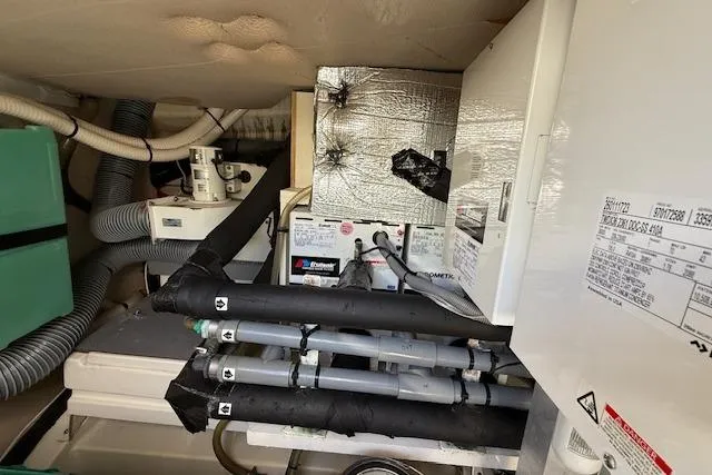 Slide: The Image of Engine room of a 2015 Prestige 500 yacht with insulated pipes and equipment. - 85