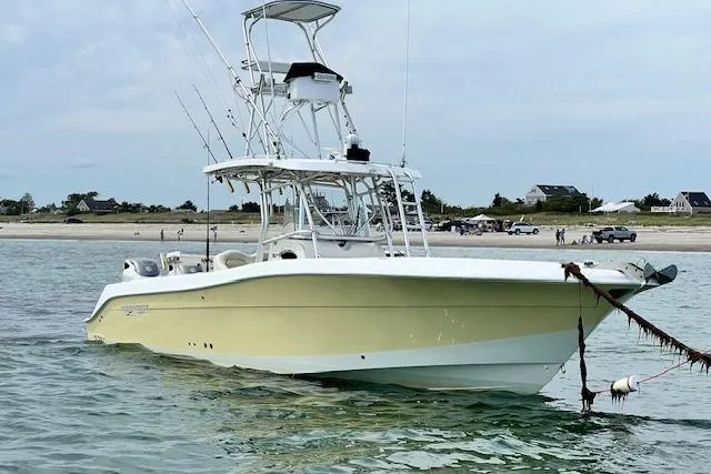 Slide: The Image of 2005 Hydra-Sports Vector 3300 CC boat anchored near a sandy beach. - 1