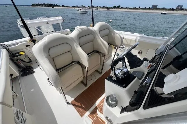 Slide: The Image of 2005 Hydra-Sports Vector 3300 CC boat interior with helm and seating, near shoreline. - 10