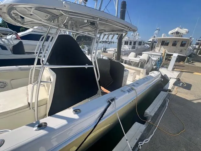 Slide: The Image of 2005 Hydra-Sports Vector 3300 CC boat docked at marina, featuring sleek design and T-top. - 17