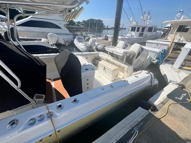 Slide: The Image of 2005 Hydra-Sports Vector 3300 CC boat docked at marina, featuring spacious seating and fishing equipment. - 19