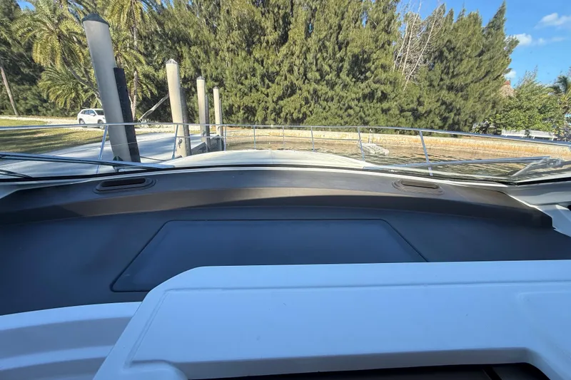 Slide: The Image of View from the helm of a 2018 Azimut Atlantis 43 yacht, docked near trees. - 10