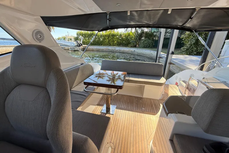Slide: The Image of 2018 Azimut Atlantis 43 yacht interior with seating, table, and canopy. - 8