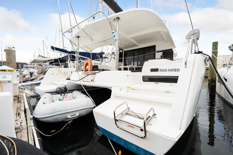 Slide: The Image of 2018 Lagoon 42 catamaran docked with inflatable dinghy. - 18