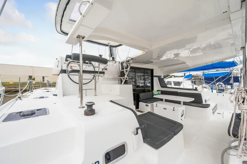 Slide: The Image of 2018 Lagoon 42 catamaran cockpit with seating and helm station. - 21