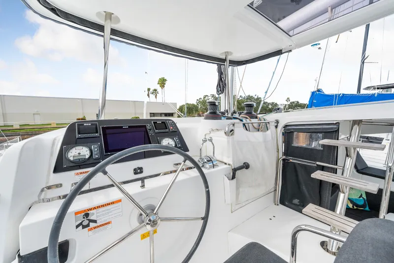 Slide: The Image of Cockpit of 2018 Lagoon 42 catamaran with steering wheel and navigation instruments. - 33