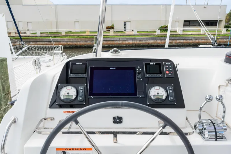 Slide: The Image of Lagoon 42 2018 yacht helm station with navigation instruments and steering wheel. - 34