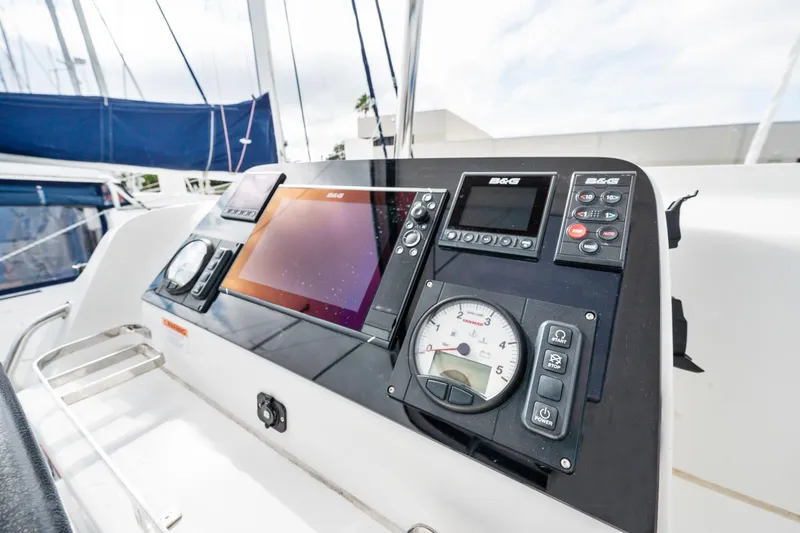 Slide: The Image of 2018 Lagoon 42 catamaran docked by a canal with clear skies. - 35