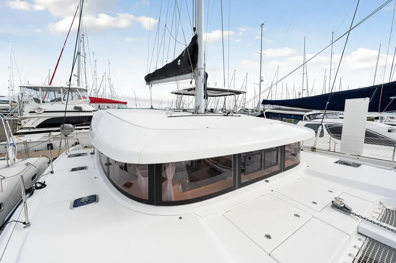 Slide: The Image of Lagoon 42 catamaran 2018 model docked at marina with other boats. - 39