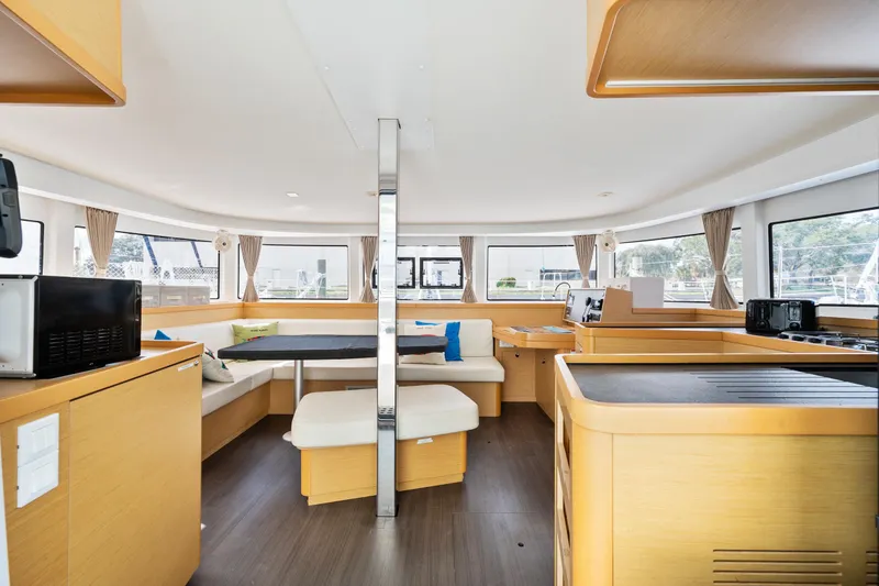 Slide: The Image of Interior of 2018 Lagoon 42 catamaran with modern furnishings and panoramic windows. - 48